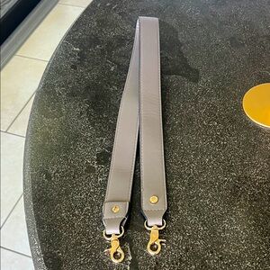 New Poppy & Peonies taupe vegan leather with gold hardware. 34" long 1.25" wide